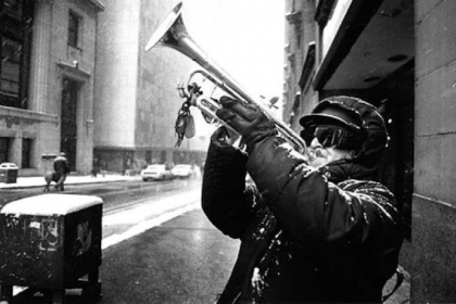 Falco Sciulli of Greenfield plays the trumpet at the corner of Fifth Avenue and Grant Street as the March 13, 1993 St. Patrick's Day Parade goes by.