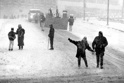 In this March 13, 1993, photo, spectators slide down the parade route on Sitxth Avenue just before the turn on Fift Avenue next to what was the County Jail.