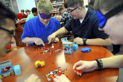 Junior David Grudowski of White Oak tries to guide Dalton Shaffer, a junior from White Oak, to the correct piece to assemble a Lego Jeep during N-Vision, a Westinghouse Electric Co. engineering career workshop for juniors and seniors at Mckeesport High School March 1.