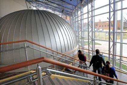 Students walk past the dome of the Angelo Taiani Planetarium in the Dupre Science Pavilion.