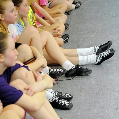 Wearing their ghillies, or soft shoes, dancers take a break from practice in the Ross studio of the Bell School of Irish Dance.