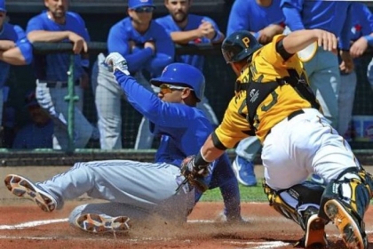 Anthony Gose of the Blue Jays slides in ahead of the tag of Pirates catcher Russell Martin Wednesday in Bradenton, Fla. The Pirates rallied to win in extra innings.