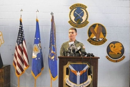 Col. Craig C. Peters, the 911th Airlift Wing commander, talks to base personnel Wednesday about the decision to keep the base open.