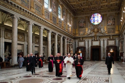 Pope Francis, flanked at left by Cardinal Agostino Vallino, and at right by Cardinal Santos Abril y Castello, walks inside St. Mary Major Basilica, in Rome today.