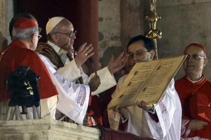 Pope Francis speaks Wednesday from the central balcony of St. Peter's Basilica at the Vatican. Cardinal Jorge Bergoglio who chose the name of  Francis, is the 266th pontiff of the Roman Catholic Church.