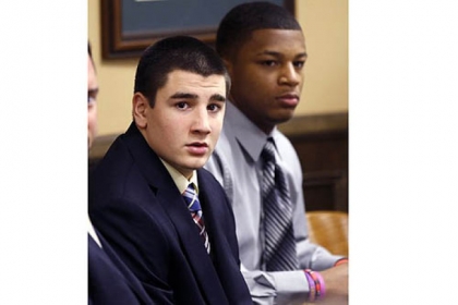Trent Mays, 17, left, and Malik Richmond, 16, sit at the defense table.