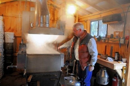 Dan Wingard checks on the maple syrup boiling in a building at his home in Gibsonia.