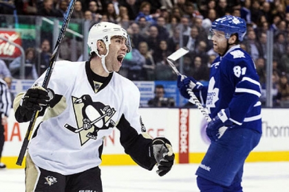 Pascal Dupuis celebrates his goal as Toronto Maple Leafs' Phil Kessel looks on during the third period.