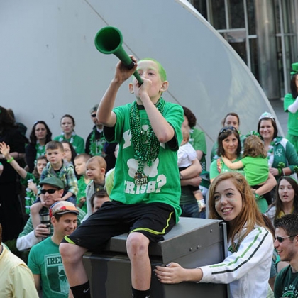 Spectators outside One Oxford Centre on Grant Street, Downtown, cheer during last year's St. Patrick''s Day Parade.