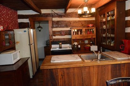 The kitchen counter tops were made with wood salvaged from the house during restoration, and the floors are the original boards put down when the house was built.