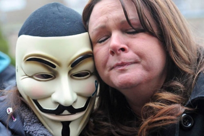 Christine Dennison, right, of Brilliant, Ohio, and a masked protestor outside the Jefferson County Justice Center respond to the delinquent decision.