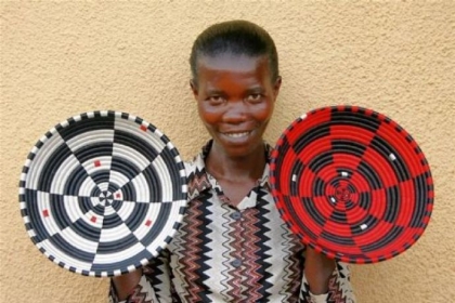 Gahaya Links cooperative member Aristude Mukashyaka, displaying her baskets, 2009.