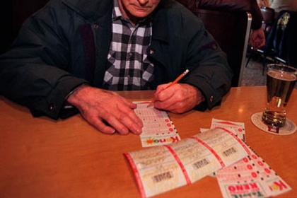 A man fills out a Keno ticket at a bar in West Virginia.