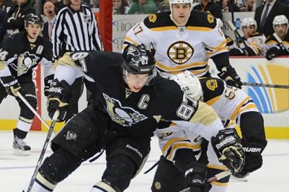 The Penguins' Sidney Crosby makes a move past the Bruins' Johnny Boychuck.