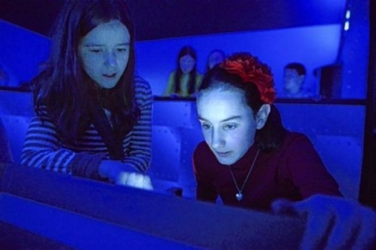 Fifth-graders Anna Rosso, 10, and Mary Flint, 10, use the simulator.