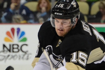The Penguins' Dustin Jeffrey battles for a loose puck in Sunday's 2-1 win against the Bruins.