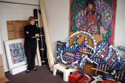 Marcy Pitts looks over artwork left by her longtime companion, Glen Whittaker.