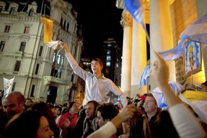 Faithful wave Vatican and Argentinian flags Wednesday as they sing outside the Metropolitan Cathedral in Buenos Aires, Argentina. Latin Americans reacted with joy on Wednesday at news that Argentine Cardinal Jorge Mario Bergoglio was elected pope. Cardinal Bergoglio, who chose the name Pope Francis, is the first pope from the Americas.