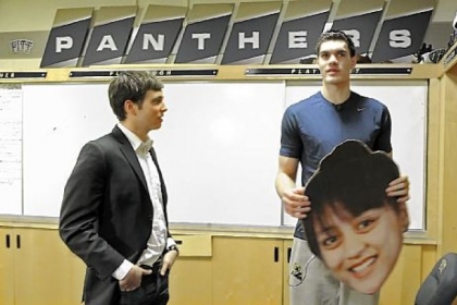 Tame and Adams in the Pitt locker room with a cutout of Adams' girlfriend that the student section in Cincinnati were using to distract him.