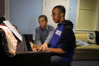 Eugene Perry teaches piano to Travonne Henderson, 14, of West Oakland, at The Corner, on Robinson Street at Terrace Street, which serves as a community center run by the West Oakland Neighborhood Council and Friendship Community Presbyterian Church.