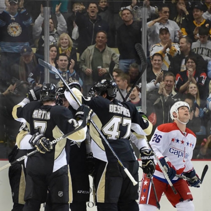 Penguins defenseman Paul Martin (7) is mobbed after scoring in the second period against the Capitals.