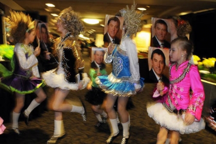 Burke Conroy Irish Dancers perform with face masks of David Malone.
