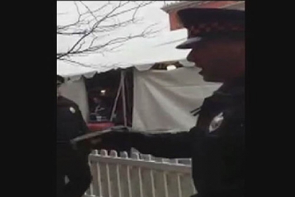In this photo from a video taken by bystander Sam Urick, Pittsburgh police detective Frank Rende is seen holding a Taser Saturday on the South Side.