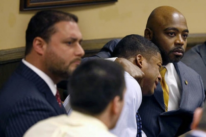 Defense attorney Walter Madison, right, holds his client, 16-year-old Malik Richmond, while defense attorney Adam Nemann, left, sits with his 17-year-old client Trent Mays, foreground. Both teens were found delinquent this morning for rape.