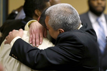 Trent Mays, 17, left, gets a hug from his father. Trent and co-defendant Malik Richmond, 16, were found delinquent for rape.