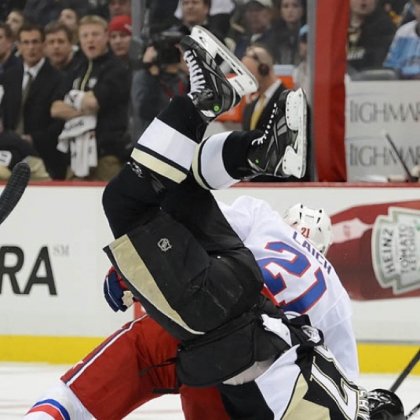 Brooks Laich of the Washington Capitals knocks Sidney Crosby head over heels in the first period Tuesday at Consol Energy Center. Crosby had the final say, though, with two assists in the Penguins' 10th consecutive victory, a 2-1 win.