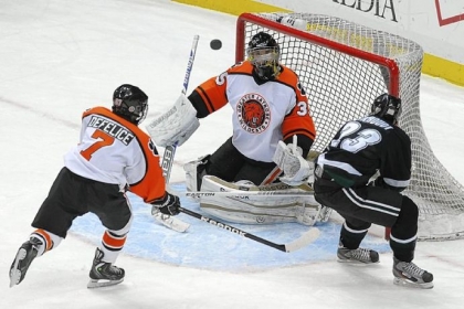 Latrobe goalie Shane Brudnok blocks a shot by Pine-Richland's Drew Berkhoudt in the Class AA Penguins Cup game Wednesday night at Consol Energy Center.