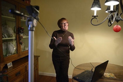 Cindy May Fenger demonstrates how she would record videos for her signing classes.
