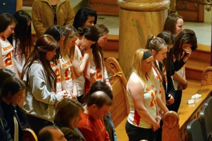 The Seton Hill University lacrosse team attends Sunday's memorial Mass for coach Kristina Quigley, killed Saturday in Carlisle, Pa.