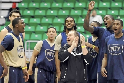 Pitt players cheer after Durand Johnson, left, hits a half-court shot to end practice Wednesday in Salt Lake City.