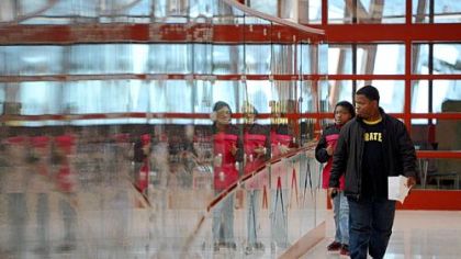 Tim Willis walks with his 11-year-old daughter, Lanyia, through the new Penn Hills High School on Friday.