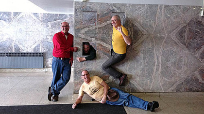Four 1976 Penn Hills graduates recreate a photo taken during their senior year of high school during a tour of the building held on Friday.