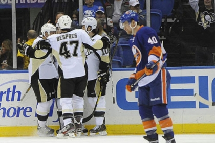 The Penguins' Craig Adams, Simon Despres and Tanner Glass celebrate Joe Vitale's goal as the Islanders' Michael Grabner skates away in the second period.