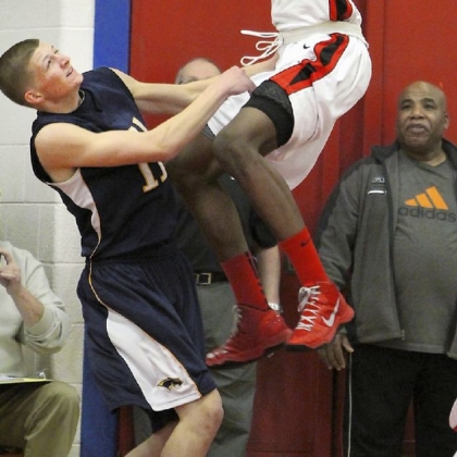 Archbishop Carroll's Derrick Jones dunks against Pope John Paul II's Brent Mahoney in the first quarter of the PIAA Class AAA tournament game March 12 in Plymoiuth Meeting.