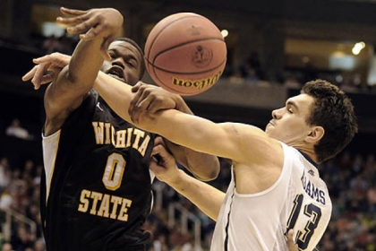 Pitt's Steven Adams reaches for a rebound against Wichita State's Chadrack Lufile in the first half.
