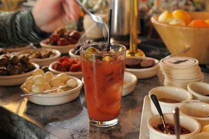 Patrons at Meat and Potatoes personalize their drinks at the make your own bloody mary bar.