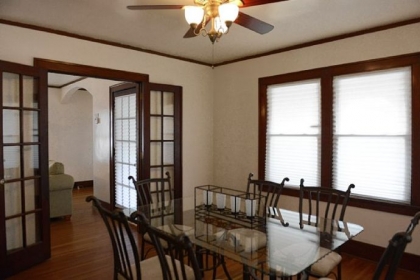 Dark-stained French doors connect the dining room and the living room.