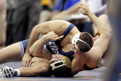 Penn State's Quentin Wright, top, pins Minnesota's Scott Schiller in their 197-pound quarterfinal match at the NCAA wrestling championships Friday in Des Moines, Iowa.