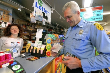 Jack Winterbottom, a Pittsburgh paramedic with Rescue 2, buys his lottery tickets from cashier Antoinette Sciulli at Smithfield News, Downtown.