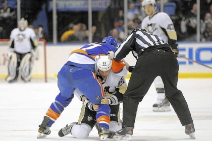 A referee separates the Islanders' Matt Martin and the Penguins' Craig Adams Friday.