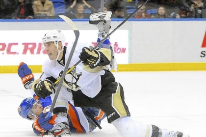 Pascal Dupuis collides with the Islanders' Andrew MacDonald Friday at Nassau Coliseum  in Uniondale, N.Y. Dupuis scored an empty net goal in the Penguins' 4-2 win.