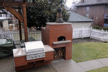 Backyard cooking area including a pizza oven.