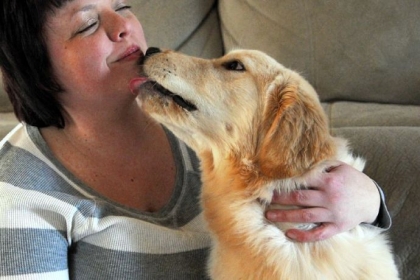 Marcy Kronz and her 7-month-old golden retriever, Dudley, in their West End home.