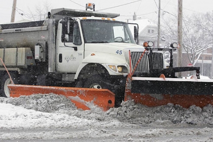 A snow plow moves wet, slushy snow from an intersection in Rockford, Ill., today, as a winter storm headed for Pittsburgh blew through that area.