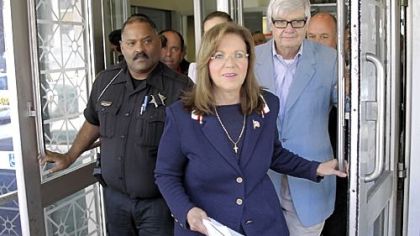 Pennsylvania Supreme Court Justice Joan Orie Melvin, center, leaves Pittsburgh Municipal Court after a hearing on charges she illegally used her state-funded staff to perform campaign work in the city.