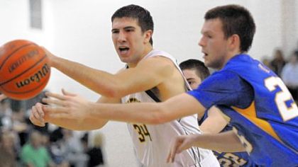 Penn-Trafford's Brian McDonough battles with Hampton's Trace McConnell for a loose ball during a game earlier this season.